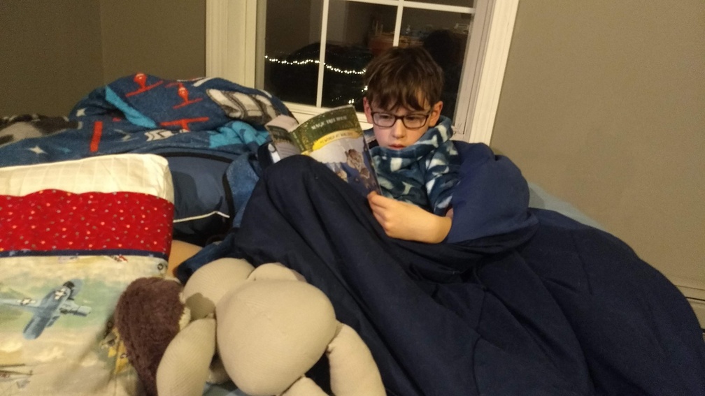 Cuddled Up to Read His Book