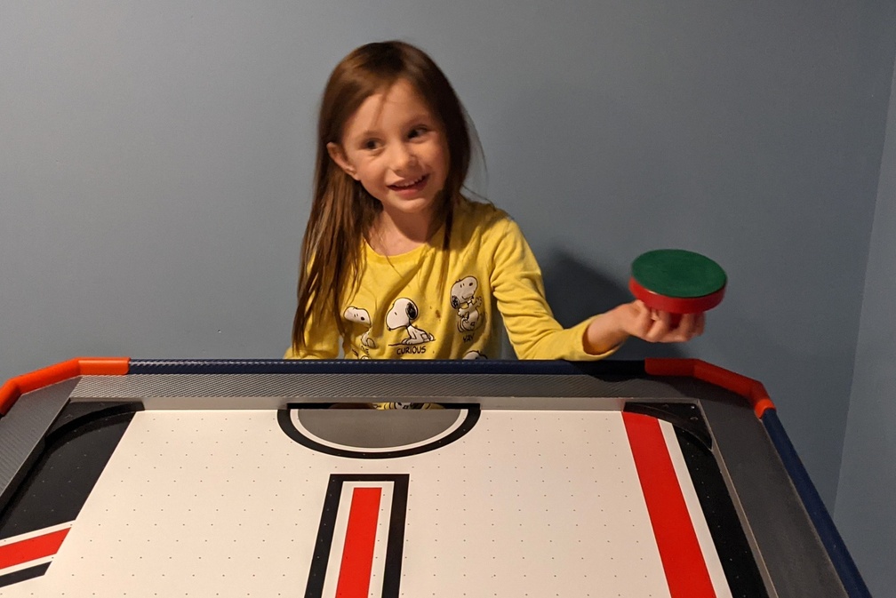 She Comes to Play Air Hockey
