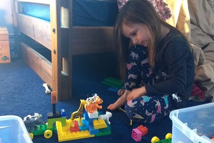 Contemplative Additions to Her Duplo Animal Tower