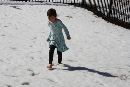 Feral Shoeless Child Enjoying Surprise Snow