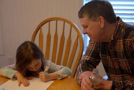 Showing Grandpa Her Writing
