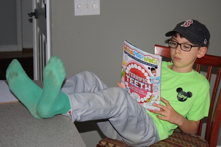 Baseball Boy Reading a Magazine
