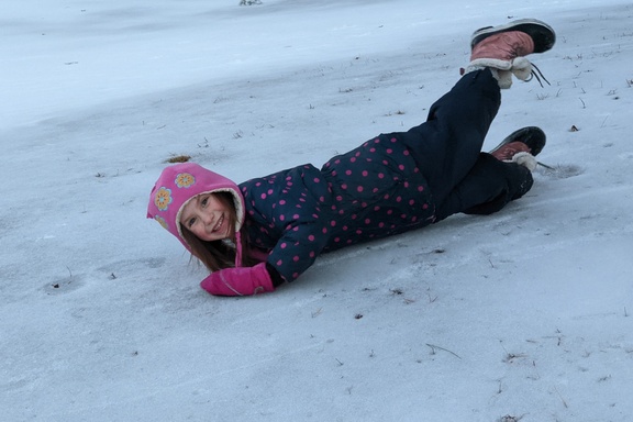 Goofy Girl Sliding Down the Ice